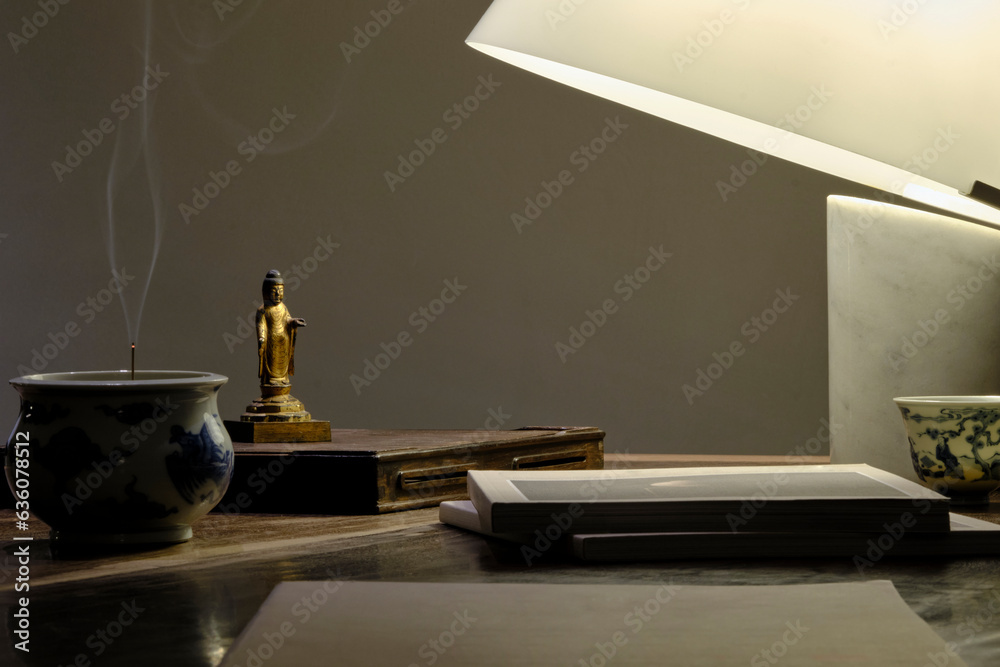 © ChaoShu Li/Stocksy - Chinese style antique bronze small buddha statue, placed at home
