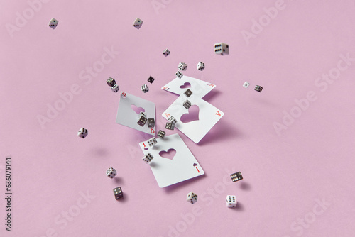 Black and white dice falling with playing cards.
