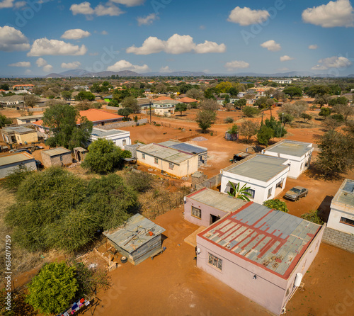 aerial view of typical modern african village in botswana, with dusty dirt roads and cubic buildings photo