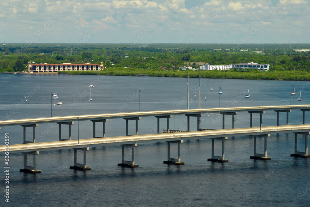 Obraz premium Barron Collier Bridge and Gilchrist Bridge in Florida with moving traffic. Transportation infrastructure in Charlotte County connecting Punta Gorda and Port Charlotte over Peace River