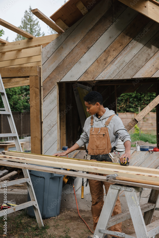 Skilled Carpenter at Work: Lifting Wood and Tools on the jobsite Skilled Carpenter at Work: Lifting Wood and Tools on the jobsite
