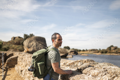 man with backpack exploring nature photo