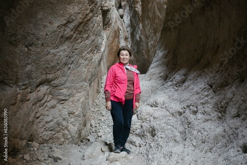 woman stands in the midst of a canyon landscape photo