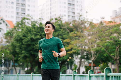 Active and sporty young asian male warming up his body