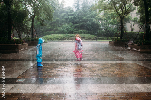 Two kids playing in the rain photo