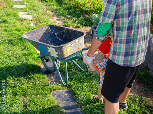 father and son pulling a cart photo