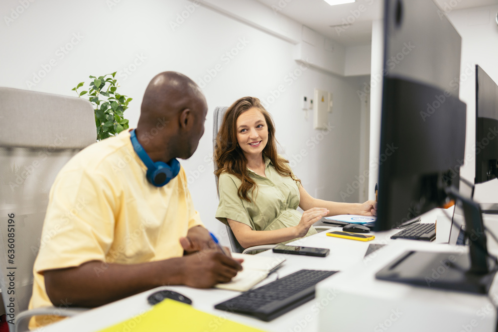 Black man and pregnant woman working in the office of a modern agency Black man and pregnant woman working in the office of a modern agency