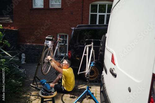 Man fixing bicycle on a sunny day