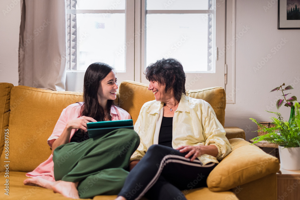 Smiling daughter and mother shopping online using tablet Smiling daughter and mother shopping online using tablet