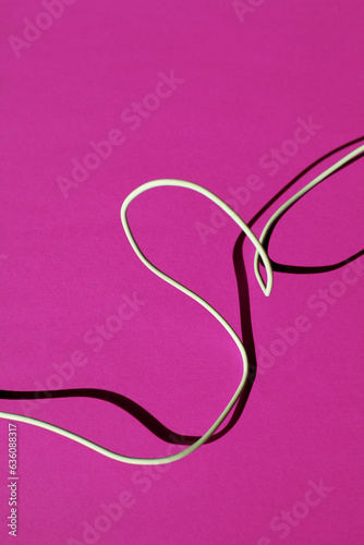 White cord on a pink backgroound photo