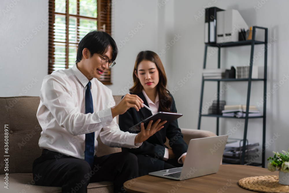 Businessman showing business data in tablet and explaining about new startup project to executive Businessman showing business data in tablet and explaining about new startup project to executive
