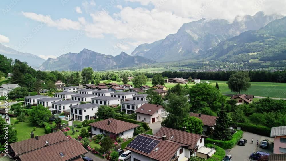 Aerial View Of Residential Homes In Bad Ragaz In Switzerland With Epic Mountain Views In The Background. Pull Back Shot Aerial View Of Residential Homes In Bad Ragaz In Switzerland With Epic Mountain Views In The Background. Pull Back Shot
