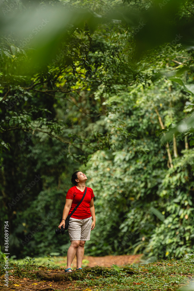 Woman looking at the trees in the jungle Woman looking at the trees in the jungle