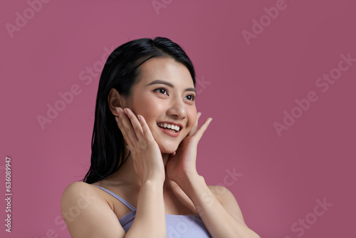 Beautiful Asian young woman touching soft cheek smile photo