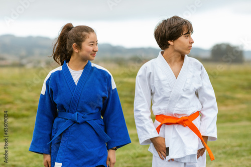 Teens in judo uniform gi outdoors photo