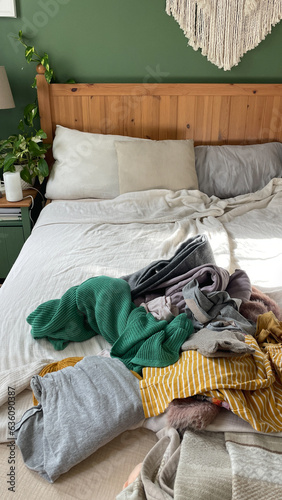 A pile of clothes on the bed. Before and after concept