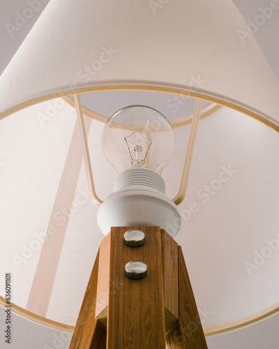 Outdated incandescent light bulb in a sleek bedside lamp 