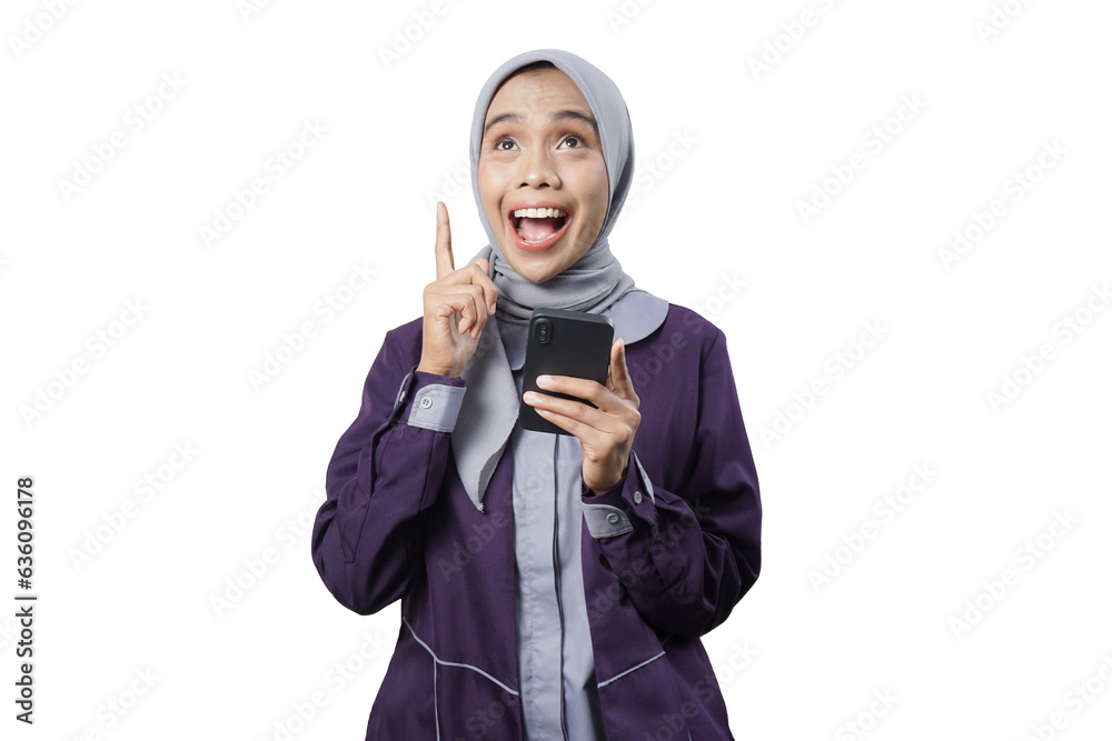 Cheerful beautiful Asian woman in casual shirt and hijab using a mobile phone Cheerful beautiful Asian woman in casual shirt and hijab using a mobile phone