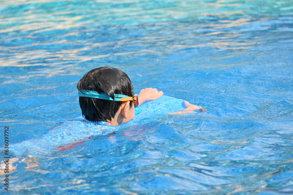 happy boy swimming in the blue pool, sport leisure activity
