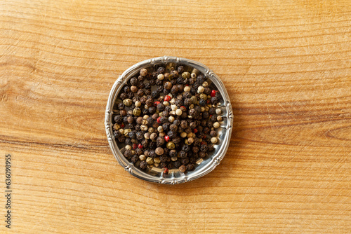 Before and after shot of peppercorns and ground pepper photo