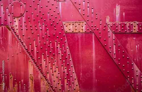red, rusty metal plates with rivets