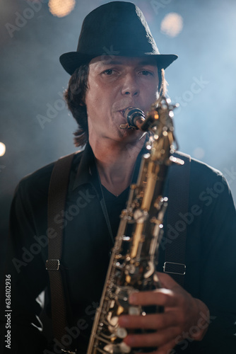 Portrait of man who plays saxophone and looks at camera