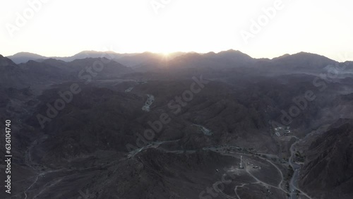 Epic sunrise: Aerial view of Wadi Shawka mountains, Ras Al Khaimah. High-angle dolly shot captures breathtaking beauty. photo