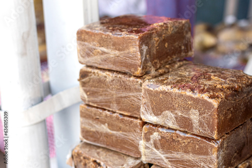 Panela blocks, sweet product derived from sugar cane popular in some Latin American countries used to sweeten food and drinks. Blocks of sugar stacked and wrapped in plastic to be sold. Traditional fo photo