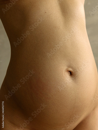 Close-up of a 4-month pregnant belly photo