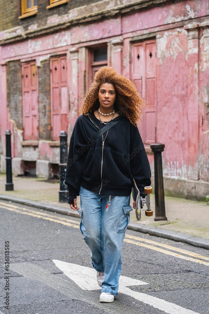 Female skater walking on street Female skater walking on street