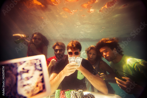 Surreal underwater poker game in swimming pool photo