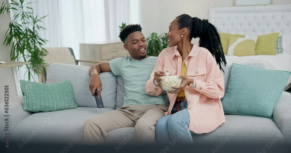Black couple on sofa with popcorn, watching tv and smile on date night ...