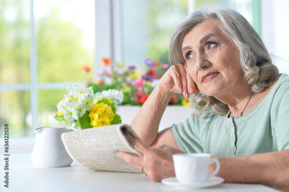 Portrait of thoughtful aged woman reading newspaper Portrait of thoughtful aged woman reading newspaper