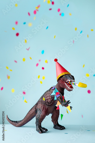 Toy dinosaur celebrating at a birthday party photo