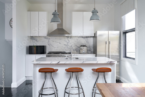 Modern kitchen with marble island bench photo