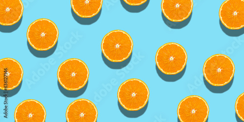 Fresh orange halves or slice on a blue background.