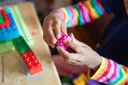 Closeup of a child's hands as she plays with blocks
