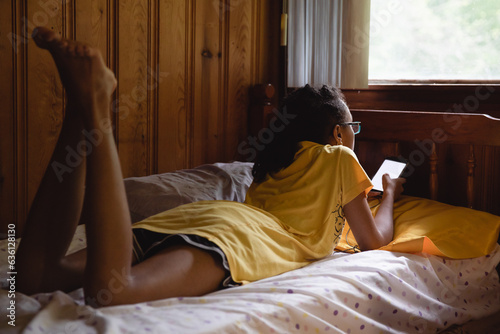 Teenager lying in a quiet bunk while at camp photo