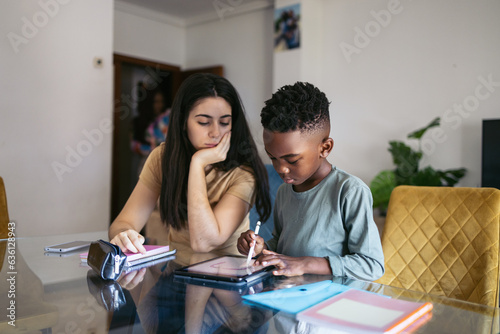 Girl babysitting a little boy at home