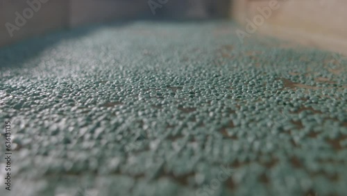 Close-Up Shot of Water Conduit Moving Recycled Plastic at a Waste Management Facility photo