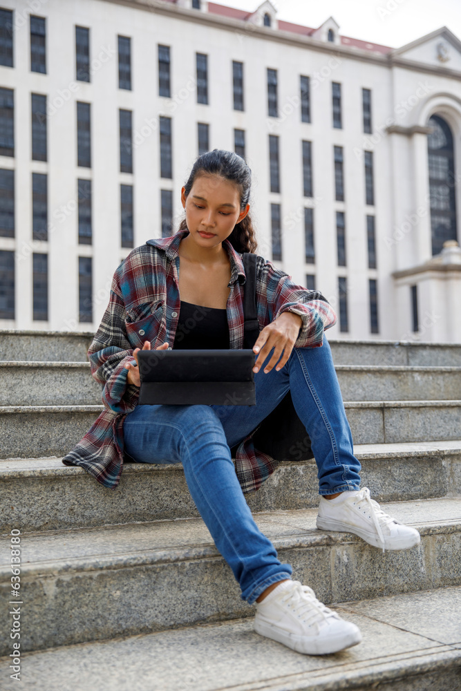 Student using digital tablet at university campus Student using digital tablet at university campus