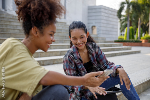 Friends sharing mobile phone content on stairs photo