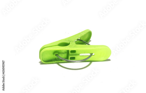 green plastic clothes pin called jepitan in indonesia, isolated on white background