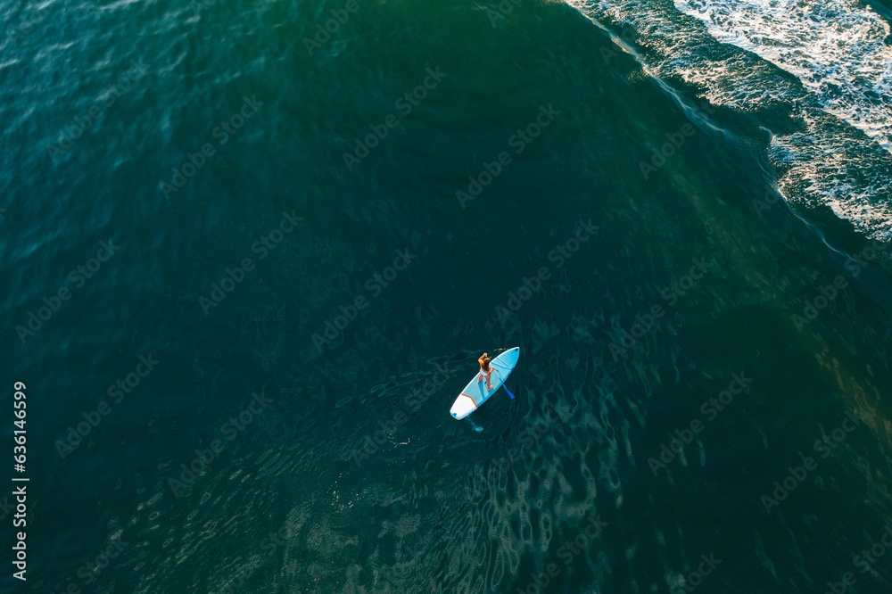 Woman on SUP paddle board Woman on SUP paddle board