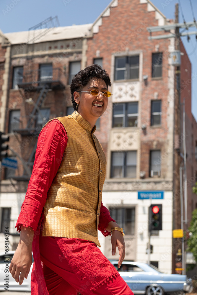Stylish nonbinary person walking through and urban setting Stylish nonbinary person walking through and urban setting