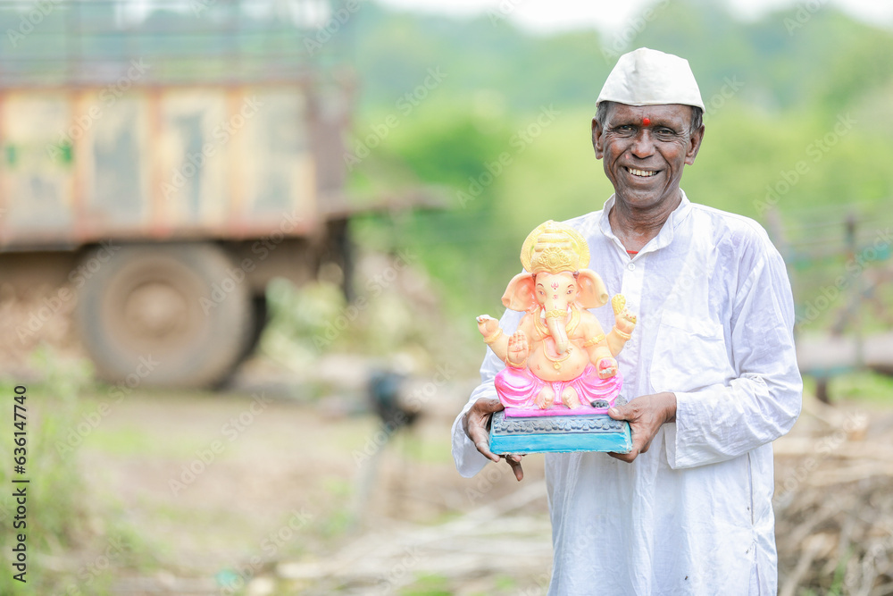 Indian old man holding Lord Ganesha idol in hands , happy old poor man Indian old man holding Lord Ganesha idol in hands , happy old poor man