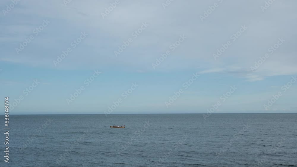 Sailing Boat In Distance At The Serene Ocean Near Norway Coastline. Wide Shot Sailing Boat In Distance At The Serene Ocean Near Norway Coastline. Wide Shot