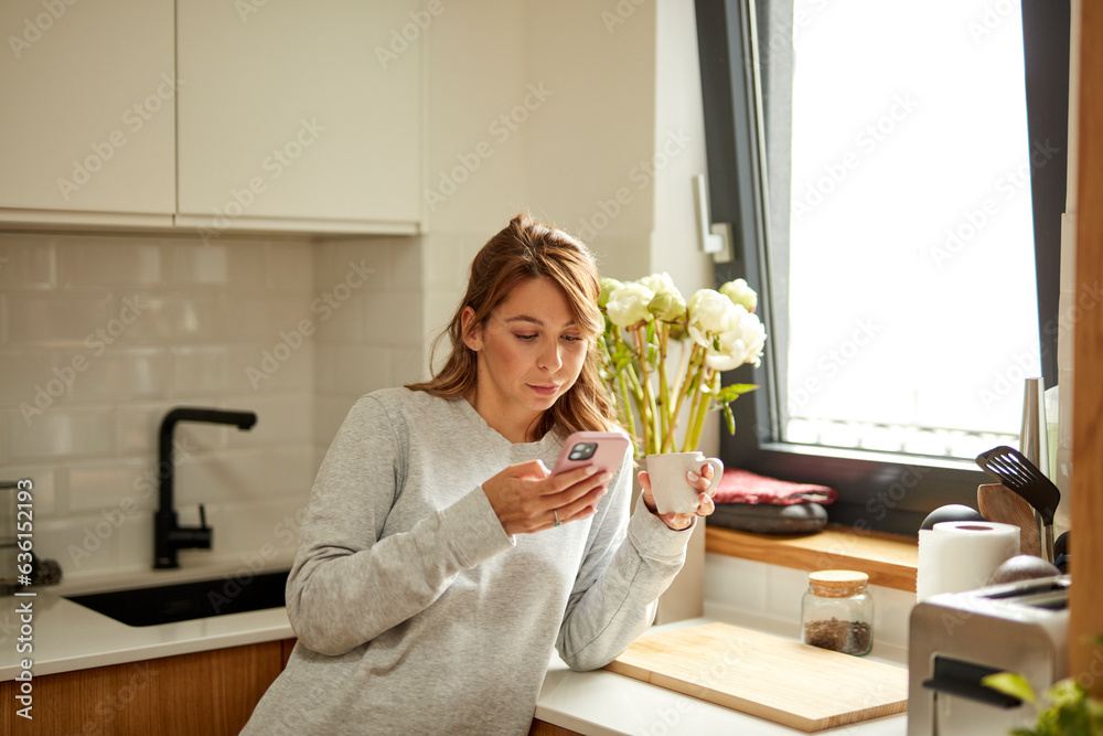 woman drinks coffee in the kitchen woman drinks coffee in the kitchen