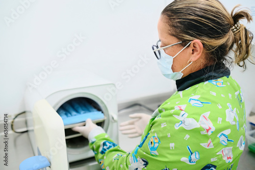Dentist at work with an autoclave photo