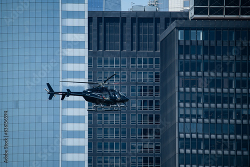 Helicopter among glass high rise buildings
 photo